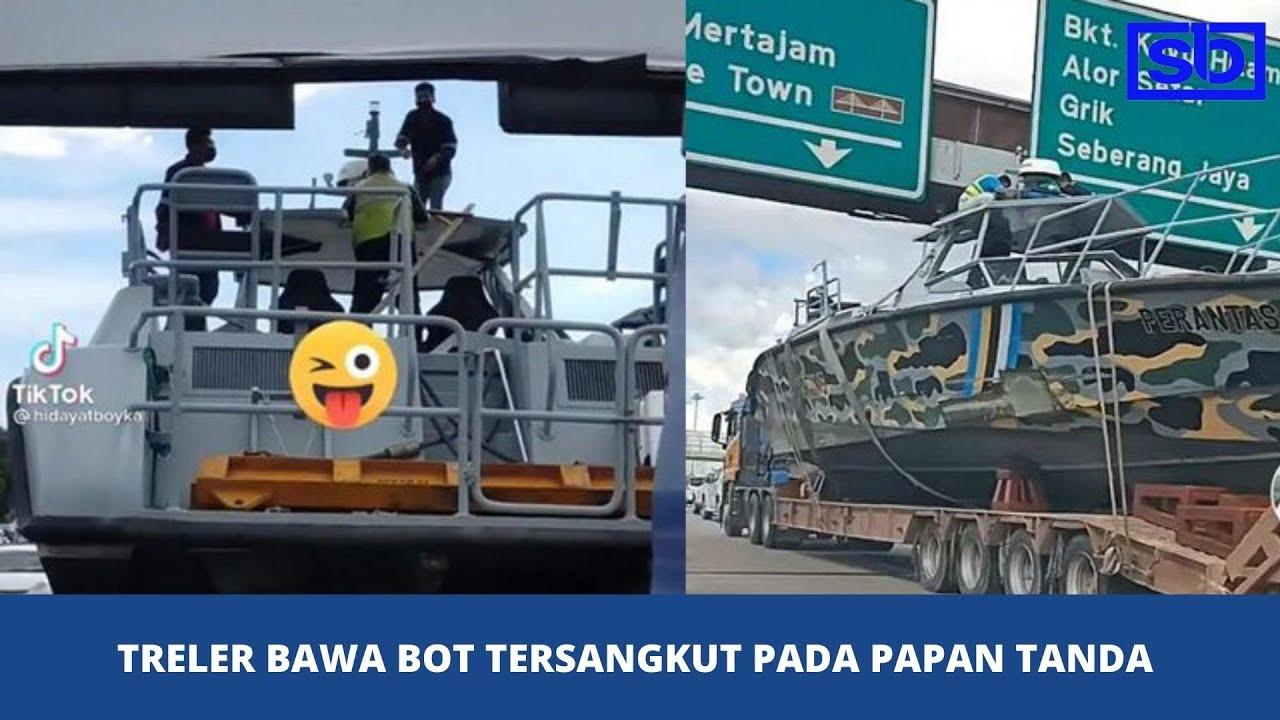 [VIDEO] Treler bawa bot tersangkut pada papan tanda